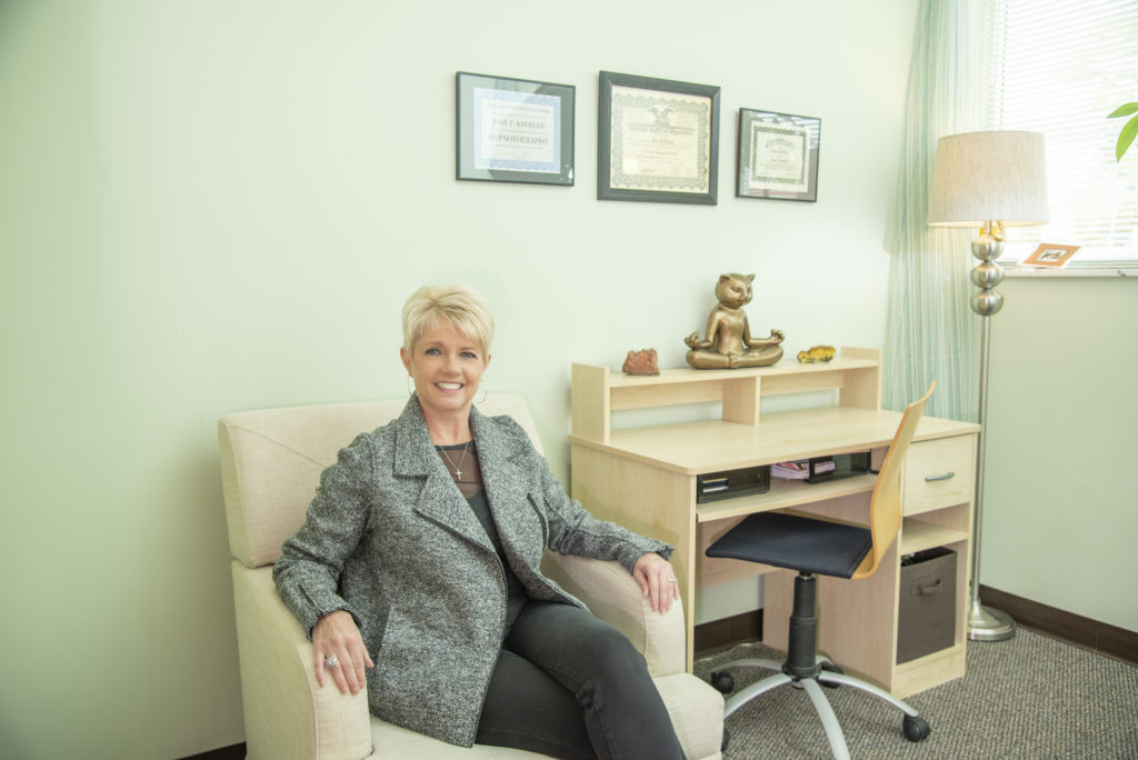 Certified Hypnotherapist Joan Krueger in her St. Louis office showcasing expertise in phobias, weight loss, and anxiety.